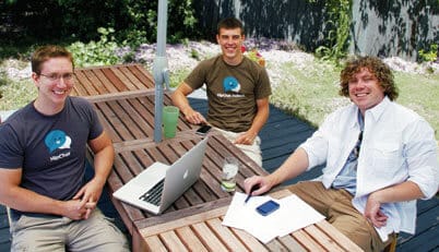 HipChat founders Chris Rivers, Garret Heaton, and Pete Curley (left to right) sitting at the table.
