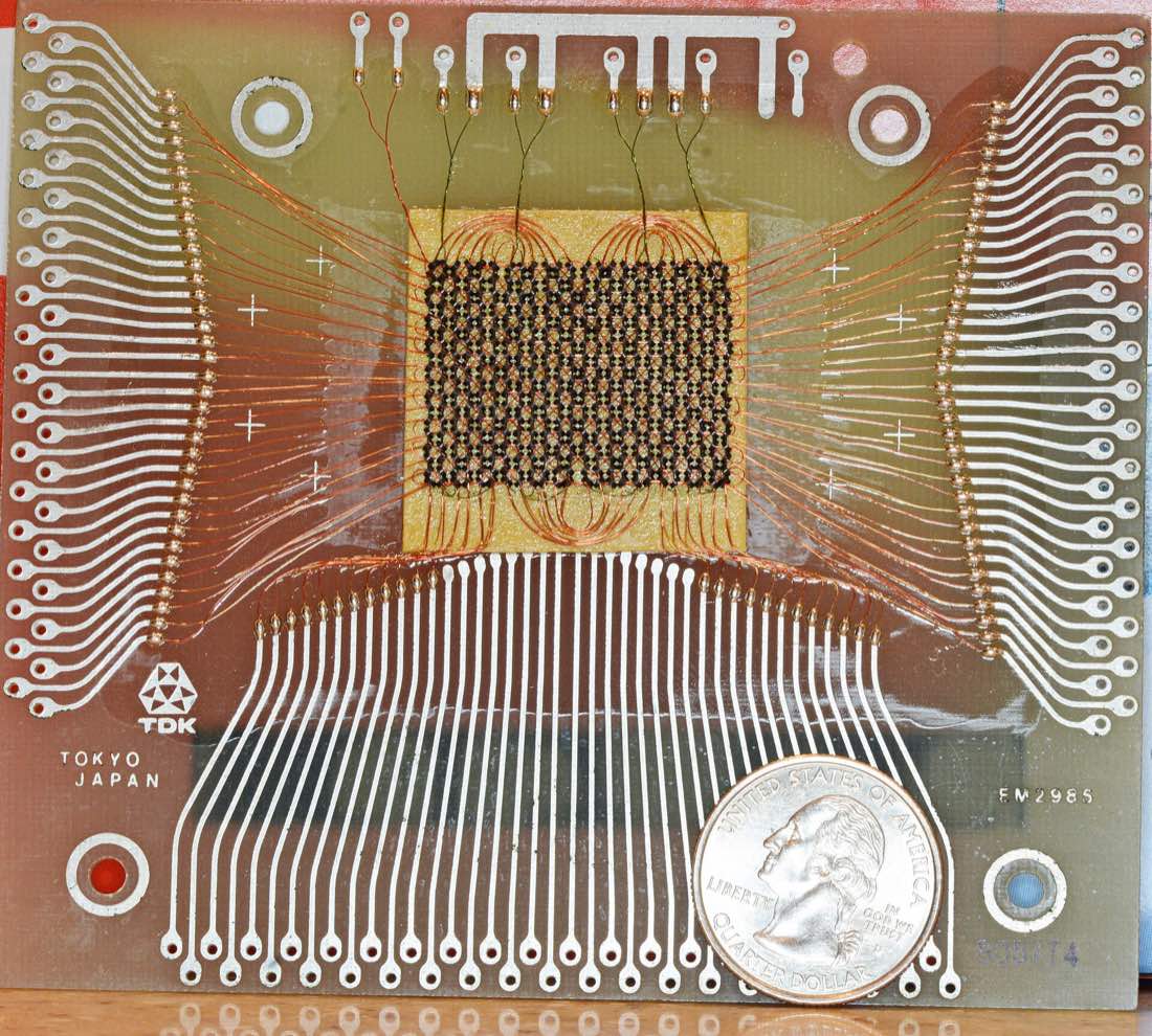 Woven magnetic-core memory grid, an early physical form of computer memory, illustrating the history of AI agent memory