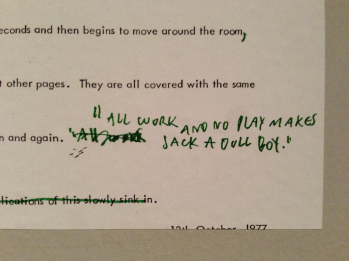 A prop replica of the "All work and no play makes Jack a dull boy" screenplay page from The Shining, at a Stanley Kubrick museum exhibit
