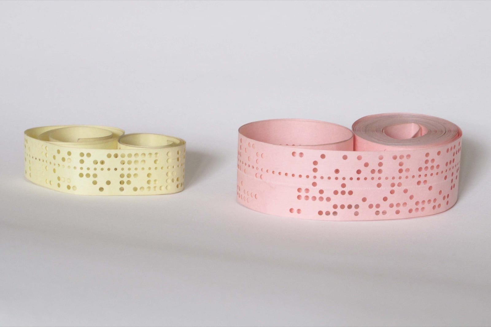Punched paper tape in five-hole and eight-hole formats, the earliest fixed-width input windows