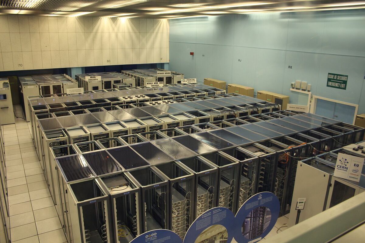 Rows of server racks with cold-aisle containment in the CERN data center, the kind of capacity hyperscalers and GPU clouds rent out